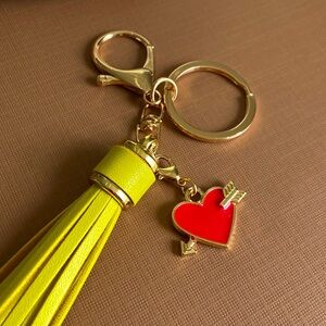 NEW. Bag charm or keychain. Faux leather tassel, removable heart charm